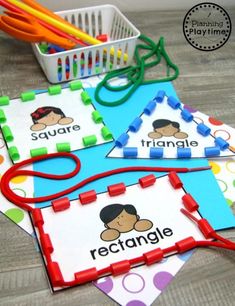 four placemats with name tags on them and scissors in the middle one has an orange string attached to it