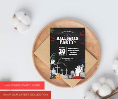 a halloween party card sitting on top of a wooden plate next to cotton flowers and cotton balls