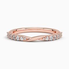 a rose gold wedding band with diamonds on the sides and an elegant twist in the middle