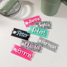 several name tags on a table next to a cup