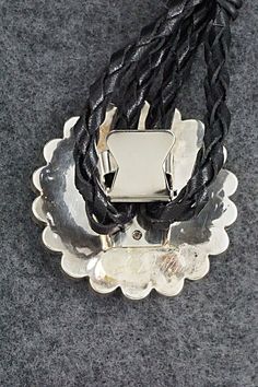 This mother of pearl, turquoise, onyx, coral and sterling silver inlay Zuni Sunface shaped bolo tie was made by Navajo silversmith Bryant Othole. The back is signed.Tie Length: 22 1/2"Length: 2"Width: 2"Tips:Length: 4 1/4"Width: 1 1/8"Free shipping on all orders! We ship with USPS and always include tracking. All orders ship within a day of payment.Returns are accepted up to 30 days after you receive your order. Just send us a message. Our shop offers cash back or store credit. The item must be Southwestern Silver Jewelry With Adjustable Cord, Adjustable Southwestern Jewelry With Sterling Silver Clasp, Silver Lariat Bolo Tie With Adjustable Cord, Silver Western Jewelry With Adjustable Cord, Western Style Silver Jewelry With Adjustable Cord, Adjustable Sterling Silver Bolo Tie For Gifts, Silver Bolo Tie With Sliding Knot As Gift, Unique Silver Bolo Ties As Gift, Unique Silver Bolo Tie As A Gift