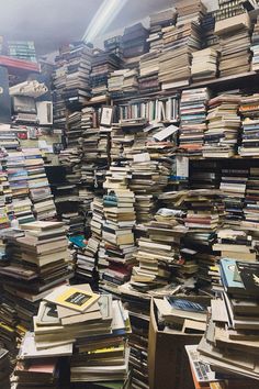 a large amount of books stacked on top of each other