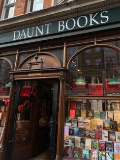 a store front with many books on display in it's windows and the words, daunt books