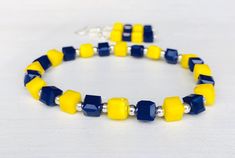 Bright yellow and blue stretch bracelet with matching earrings. This stretch bracelet set is made with faceted 8mm glass beads with strong elastic cord and silver plated ear wires. This blue and yellow jewelry set is perfect for representing your team colors.  MY ENTIRE COLLECTION https://www.etsy.com/shop/MiksJewelryShop Please message me with any questions you may have. - Mikaila Don't forget to FAVORITE ♥️ YOUR favorite items & also my shop so you can easily find them again. Team Bracelets, Blue Game, Yellow Jewelry, Stackable Bracelets, Bracelets For Women, School Colors, Yellow And Blue, Bright Yellow, Stretch Bracelet