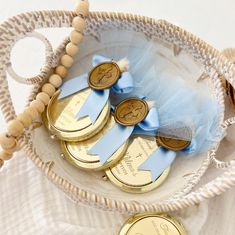 a basket filled with lots of gold and blue coins on top of a white table