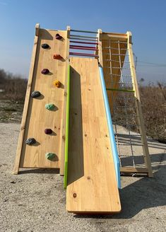 a wooden climbing wall with rocks on it