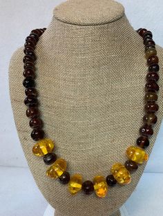 Stunning amber and glass bead necklace, 6 amber pieces surrounded by round, brown, glass beads.  26 inches long with brass lobster claw clasp. Adjustable Brown Beaded Necklaces With Oval Beads, Adjustable Round Brown Beaded Necklace, Adjustable Brown Beaded Round Necklace, Adjustable Brown Round Beaded Necklace, Adjustable Brown Beaded Necklace, Adjustable Single Strand Brown Beads, Handmade Brown Czech Glass Beads, Vintage Amber Beaded Necklaces With Round Beads, Brown Glass Beads For Jewelry Making