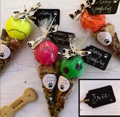 dog treats in bags with tags on them and a bone for a treat to eat