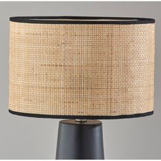 a table lamp with a black base and a brown shade on it's side