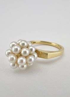 Vintage Mikimoto 18k Yellow Cultured Akoya Pearl Disco Ball Cluster Ring Size: 6 - Can be Resized Weight is 5.8 Grams on my scale Metal: 18k Yellow Gold - Tested And Confirmed Amazing Cultured Akoya Pearl Disco Ball Cluster Design Ring Face Size is 11mm Wide in the Center & Has About a 13mm Rise Off Your Finger When Worn Designer Signed: Mikimoto - (M In Clamshell) In Great Condition, Any Questions Please Feel Free to ask Thank you White Cluster Ring Stamped 14k, Modern Yellow Gold Pearl Ring For Anniversary, Modern Yellow Gold Pearl Ring For Formal Occasions, Timeless Gold Rings With High Luster, Modern 14k Gold Pearl Ring For Wedding, White 14k Stamped Cluster Ring, Modern Round Pearl Ring In Yellow Gold, Modern 14k Yellow Gold Pearl Ring, High Luster Yellow Gold 14k Ring