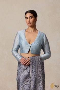 "Sensual and fabulous. This is a feminine blouse with a deep, plunging neckline hooked delicately in the front.\n\n\nColor - An shade of Powder Blue\n\n Fabric - Pure Chanderi or Silk by Cotton\nPlease allow 10-12 business days for despatch.\u00a0\n\n" India Inspired, Feminine Blouses, Blouse Design Models, Silver Screen, Blue Silk, Blouse Design, Powder Blue, Plunging Neckline, Blue Fabric