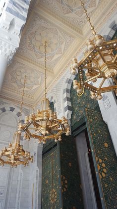 chandelier hanging from the ceiling in an ornate building