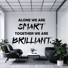 a living room with two black chairs and a white coffee table in front of a wall that says, alone we are smart together we are brilliant