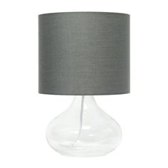 a clear glass lamp with a grey shade on the bottom and a gray linen shade on the top