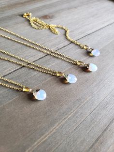 Beautiful white and iridescent opal stone necklace with petite resin pendants on elegant gold plated chain. Brilliantly colorful opaque opal pendants, elegant rainbow colors, and paired with 18 karat gold plated stainless steel necklace chain. Colorful hues mingle together to create this naturally stunning stone jewelry piece. ♡ Made with 18 karat gold plated stainless steel necklace chain at 18 inches of length. Boldly colorful resin jewelry ♥ Be sure to check out the NECKLACE section at Earrin Gold Clavicle Chain Necklace With Moonstone, Gold Moonstone Necklace With Adjustable Chain, White Moonstone Necklace With Delicate Chain, White Opal Necklace With Delicate Chain, Gold Opal Charm Necklace As Gift, Gold Dainty Opal Charm Necklace, Delicate Gold Opal Necklace, Dainty Gold Opal Charm Necklace, Minimalist Gold Opal Necklace