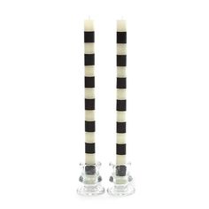 two candles with black and white stripes on them