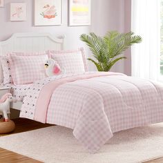 a bed with pink and white checkered comforter set in a girls'bedroom