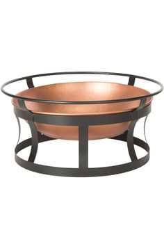 a metal and copper bowl sitting on top of a table