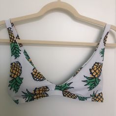 Nwot Pineapple Print Bikini Top. White With Green, Yellow, And Black Pineapple Prints. Features A Clip Closure In The Back, Adjustable Straps, And Original Removable Pads. Size Small Please Leave Any Questions Or Comments Below! Offers Are Welcomed! I Can Ship Asap :) Fitted Fruit Print Swimwear For Vacation, Fruit Print Beachwear Swimwear For Beach Season, Summer Beach Swimwear With Fruit Print, Cute Green Swimwear For Beach Season, Summer Swimwear With Fruit Print For Poolside, Cute Printed Swimwear For Vacation, Fruit Print Swimwear For Beach Season, Cute Green Swimwear For Beach, Beach Season Swimwear With Fruit Print