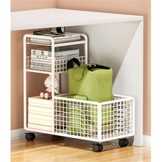 a white shelf with some green bags on top of it next to a wooden floor