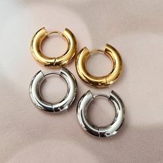 Get on trend this summer with these chunky and thick huggie hoops in either gold or silver tone. This is a beautiful and fun pair of stainless steel chubby huggies in either 12mm or 16mm. You can choose between rhodium silver plated or gold plated and enjoy these in fashion hoops all beach day long! All earrings come beautifully and simply packaged in a box and bow ready for gifting. CARE INSTRUCTIONS• It is not recommended to sleep, shower or exercise in plated jewelry. Trendy Stainless Steel Huggie Hoop Earrings, Huggies Hoop Earrings, Crown Decor, Chunky Gold Hoop Earrings, Earring Trends, Gift Accessories, Gold Hoop Earrings, Jewelry Plate, Earring Necklace