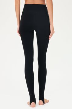 Our famous, form fitting high waist legging redesigned as a stirrup tight. Our ultra luxe Airweight fabric has a supremely soft hand and second skin comfort. BEST FOR: hot yoga, barre, Pilates. Model is 5'10" and wears a size small. Compressive Smoothing Yoga Pants In Athleisure Style, Sporty Yoga Bottoms With Smoothing Feature, Sporty Smoothing Leggings For Yoga, Compressive Smoothing Yoga Pants Athleisure, Compressive Smoothing Yoga Pants, Sporty Smoothing Tights For Yoga, Sleek Supportive Bottoms For Training, Sporty Smoothing Leggings For Pilates, Smoothing Athleisure Tights For Yoga