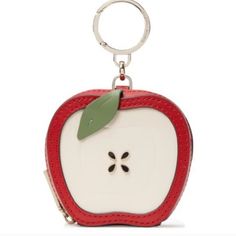 an apple shaped keychain with a green leaf on the front and bottom part