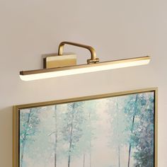 a painting is hanging on the wall next to a light fixture with an acrylic shade