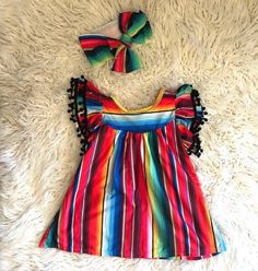 How fun and festive is this Serape Dress?!  And now in Pink! 💗 If you're anything like me, and love all things Serape, then you'll love this dress. ❤️   2-3t is 20" long, 3-4t  21" long and the 4-5t is 22" long.  Each dress is unique and color placement will vary. A bestseller for good reason! 💥 The Red Serape are finished and will be ready to ship next week 6/7!!  Woot woot! Order now so you don't miss out!More Razels! razels.etsy.com Playful Colorful Pattern Dresses For Vacation, Playful Beach Dress With Colorful Pattern, Rainbow Cotton Dress For Playtime, Rainbow Cotton Playtime Dress, Playful Rainbow Cotton Dresses, Rainbow Summer Dress For Playtime, Rainbow Summer Dresses For Playtime, Summer Rainbow Playtime Dress, Playful Colorful Summer Dresses