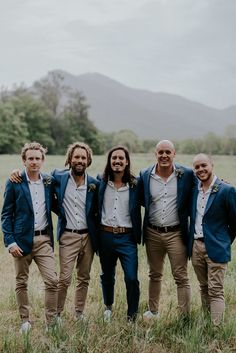 a group of men standing next to each other in a field