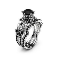 a black diamond engagement ring set on top of a white background with an intricate design