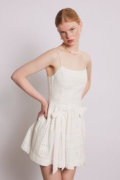 Complete with its mini length and a shirred back detail, our Penelope dress in white broderie truly sums up summer. •Mini length •Adjustable straps •Shirred back panel •100% organic cotton •Select your normal size •Designed in London MODEL INFO: Model is 5'10, is wearing a UK 10 and the length is 84cm from the shoulder.