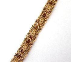 Picture is worth a thousand words,this beautiful 14k solid yellow gold bracelet with intriguing wave and twisted rope chain borders,slide in clasp and safety catch ,weight is 18.4 grams . Height is 1/2 inch,thickness 3 mm,total length from end to end is 8 inches,less 5/16 when closed. Condition like new ,a high quality piece. #729 Formal Yellow Gold Rope Chain Bracelet, Formal Rope Chain Bracelet Jewelry, Formal Rope Chain Bracelet, Elegant Formal Rope Chain Bracelet, Elegant Gold Rope Chain Bracelet For Formal Occasions, Elegant Formal Gold Rope Chain Bracelet, 18kt Gold Jewelry, Gold Waves, Yellow Gold Bangle