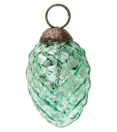 a green glass object with a metal handle