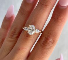 a woman's hand with a diamond ring on it