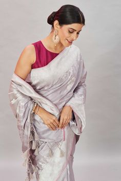 Look your ethnic best on special occasions in this light grey Katan Banarasi saree. It has silver zari border and zari buta. The saree comes with a pink blouse piece. Disclaimer: The shown stitched blouse on the model is for display purpose only. The saree comes with a matching blouse piece and finished with fall and piko. Traditional Silver Pre-draped Saree For Eid, Silver Saree With Unstitched Blouse, Traditional Drape, Silver Blouse Piece With Traditional Drape For Eid, Silver Saree With Traditional Drape For Celebration, Silver Saree For Celebration With Traditional Drape, Silver Saree For Celebration In Traditional Drape, Traditional Silver Saree For Celebration, Silver Banarasi Silk Blouse Piece, Transitional Season Festive Silver Saree