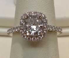 an engagement ring with a cushion cut diamond in the center