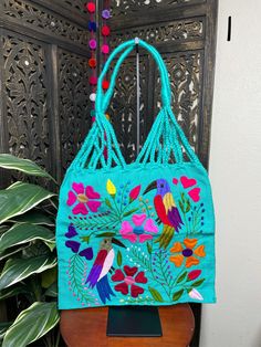 "Artisanal Handwoven Mexican Floral Tote Bag, great for your Beach or Boho look. Eco-friendly, super handy for groceries or to carry your books. Overview *Thread material *approximate measurements: 15\" tall x 16\" wide Care *hand wipe only *delicate care Please email me your questions before buying. All of my items come from a smoke and pet free environment. I WILL BE PROCESS YOUR ORDER IN 1-2 DAYS. If you need the item expressed shipped please contact me to request it and the listing will be a Embroidered Shoulder Beach Bag For Daily Use, Embroidered Double Handle Vacation Bags, Embroidered Rectangular Bucket Bag For Travel, Green Satchel Canvas Bag For Summer, Embroidered Rectangular Beach Bag, Embroidered Rectangular Beach Bag For Daily Use, Summer Embroidered Rectangular Bag, Rectangular Embroidered Beach Bag, Embroidered Rectangular Summer Bag