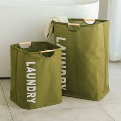 two laundry bags sitting next to each other on the floor