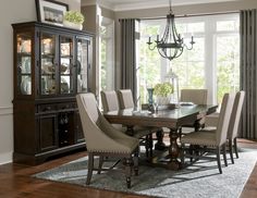 a dining room table with chairs and a china cabinet