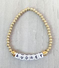 Gold Name Bracelet ✨✨ Made with 18k gold filled beads so your bracelet won't tarnish ✨✨ Get your name, your last name, your kids names or whatever you want. This little cute bracelet goes with any stack and looks good by itself ✨ Made with 18k gold filled round beads and 4mm square letters **Also available in Silver and Rose Gold** Please put name or word in Personalization Section* CARING TIPS FOR YOUR JEWELRY ⭐️Treat and store with care. ⭐️ For longevity, avoid exposing your jewelry to water. ⭐️ Avoid having direct contact with lotions, perfumes, sanitizers as these chemicals may cause discoloration of your jewelry. Personalized Yellow Gold Beaded Bracelets With Round Beads, Personalized Yellow Gold Beaded Bracelets, Personalized Gold Jewelry With Round Beads, Gold Jewelry With Round Beads For Personalized Gift, Personalized Gold Name Bracelet With Round Beads, Personalized Round Bead Gold Bracelets, Gold Jewelry Bracelet With Letter Beads, Yellow Gold Bracelet With Letter Beads As Gift, Gold Jewelry With Letter Beads For Friendship