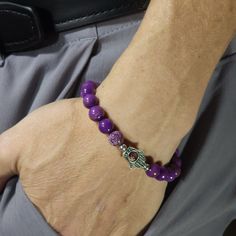 PLEASE READ FULLY *SIZING INSTRUCTIONS BELOW* This bracelet is made of all pure 8mm purple Mica with platinum-plated sterling silver beads and a silver-plated Fatima's hand with a colored, glass Evil Eye that spins.  You can select from a variety of colors for the eye!   Purple Mica is where Lepidolite gets its color from and shares many of the same metaphysical properties.  Purple Mica promotes strength, relaxation, tranquility, and emotional healing.  Made with care by me. *Sizing: 1st, measur Violet Evil Eye Bracelet, Hand Of Fatima, Emotional Healing, Sterling Silver Bead, Stretch Bracelet, Stretch Bracelets, Evil Eye, Arm Band, Natural Gemstones