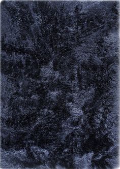 an area rug with dark blue fur on it