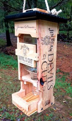 a wooden birdhouse with wine bottles hanging from it's sides and the words devil's cut written on its side