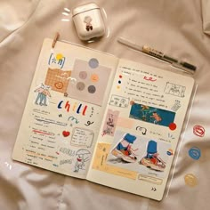 an open notebook with stickers on it next to a computer mouse and other items