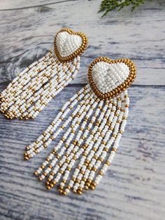 Fringed hearts for your lovely day or night!These earrings can also be a great gift idea.The earrings are light not heavy.Length:3.2 inch (8 cm) Gold Beaded Heart Earrings For Gift, Gold Beaded Dangle Heart Earrings, Handmade Gold Beaded Earrings For Valentine's Day, Wedding Beaded Heart-shaped Earrings, White Heart Beads Earrings For Wedding, White Heart Beaded Dangle Earrings, Gold Heart Beaded Earrings For Party, Handmade White Heart Earrings For Party, Gold Heart Shaped Beaded Earrings For Party