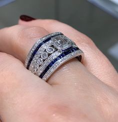 Dazzle everyone around you whenever you are wearing this mesmerizing sapphire and diamond ring. It looks so royal, and that is exactly what you will feel whenever you slip it on.Metal: 18K White GoldRound 136 Diamond Weight: 0.63ct t.w.Diamond 91 Baguette weight: 0.46ctw Sapphires 46 : 1.27ct t.w. Estimated production time is 4 - 5 weeks. Luxury Lab-created Sapphire Ring With Diamond Cut, Luxury Sapphire-colored Diamond Ring With Diamond Cut, Luxury Sapphire Diamond Ring With Diamond Cut, Luxury Sapphire-colored Diamond Ring, Luxury Blue Diamond Ring With Single Cut Diamonds, Luxury Sapphire Diamond Ring With Vvs Clarity, Blue Ring With Single Cut Diamonds, Fine Jewelry, Exquisite Diamond-cut Sapphire Ring, Luxury Blue Diamond Ring With Accents