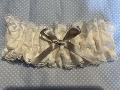 This is a beautiful lace bridal garter the lace is 7cm wide on the inside of the garter you can have your initials or names and the date if your wedding embroidered in any colour you choose you can choose whatever ribbon you would like on the front of the garter, the garter is a a regular size but I can make it larger or smaller. It will be gift boxed. Adjustable Bridal Accessories For Ceremony, Adjustable Lace Bridal Accessories For Ceremony, Elegant Adjustable Bridal Accessories For Wedding, Adjustable Cream Bridal Accessories For Ceremony, Adjustable Cream Bridal Accessories As Gift, Elegant Cream Lace For Gifts, Bridal Garter Lace, Wedding Garters, Bridal Garter