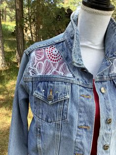 Embellished denim jacket, size large. Measures 20 1/2" across chest when buttoned. Light wash denim, rivet details, button closure. I cut out the back and front yoke and insert a beautiful light blue, sheer floral embroidered fabric. It was difficult to photograph the embroidered fabric, but is a beautiful blue that matches the jacket perfectly. Spot clean only!  This gorgeous jacket is one-of-a-kind, and would make an awesome gift for the women who appreciates unique items! Spring Recycled Denim Button-up Jacket, Spring Recycled Denim Jacket With Button Closure, Fitted Denim Jacket In Recycled Denim, Fitted Recycled Denim Jacket, Spring Recycled Denim Fitted Jacket, Spring Fitted Recycled Denim Jacket, Fitted Medium Wash Recycled Denim Jacket, Fitted Long Sleeve Denim Jacket In Recycled Denim, Spring Festival Dark Wash Denim Jacket