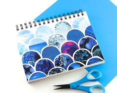 an open spiral notebook on top of a blue surface